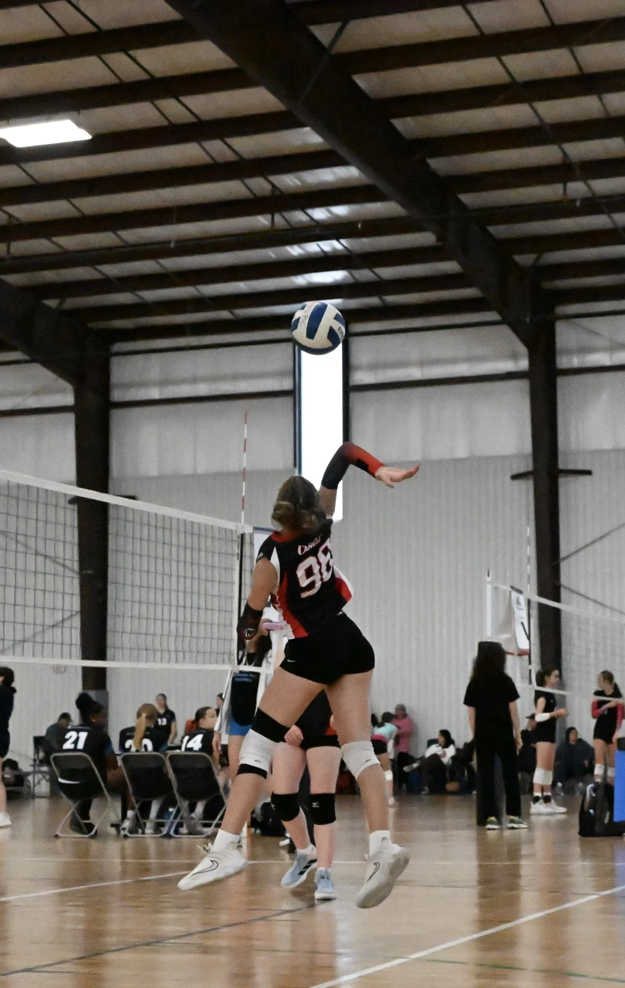 OKC Ignite player attacking at the net mid-jump during a match